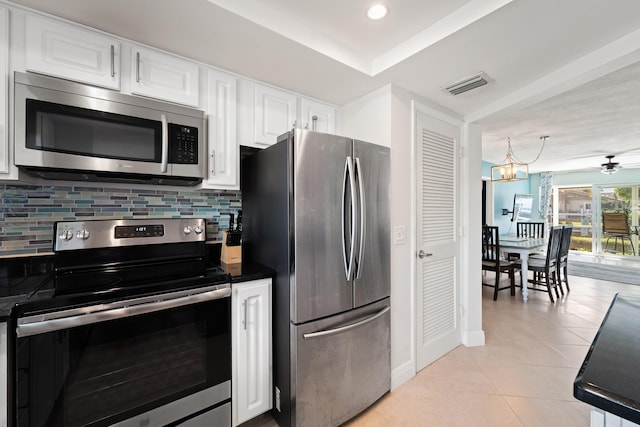 kitchen featuring stainless steel appliances, white cabinetry, tasteful backsplash, and light tile patterned flooring