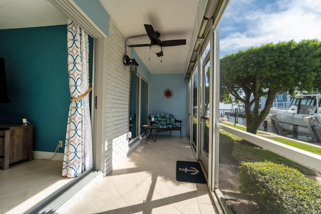 sunroom featuring ceiling fan