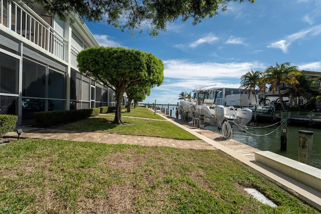 exterior space featuring a water view, a yard, and a dock