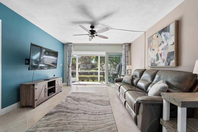 living room featuring light tile patterned floors, a textured ceiling, and ceiling fan