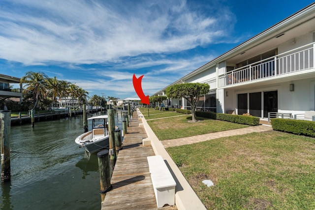 dock area with a water view and a yard