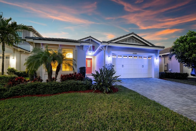 view of front of property featuring a garage and a yard