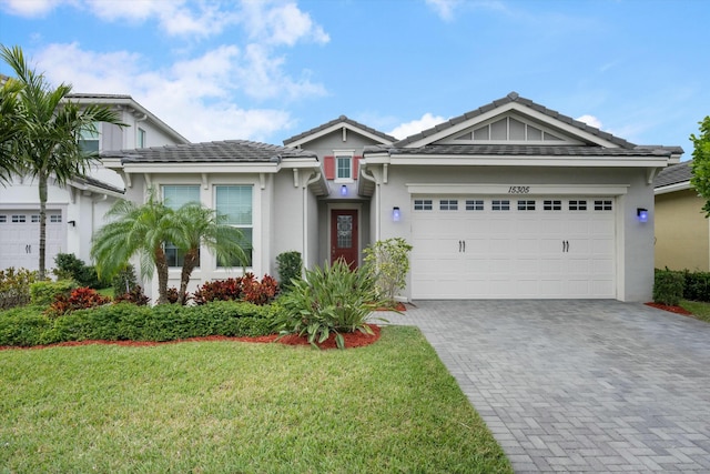 view of front facade featuring a front yard and a garage