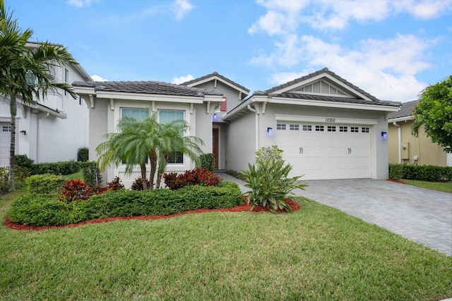 ranch-style home featuring a front lawn and a garage