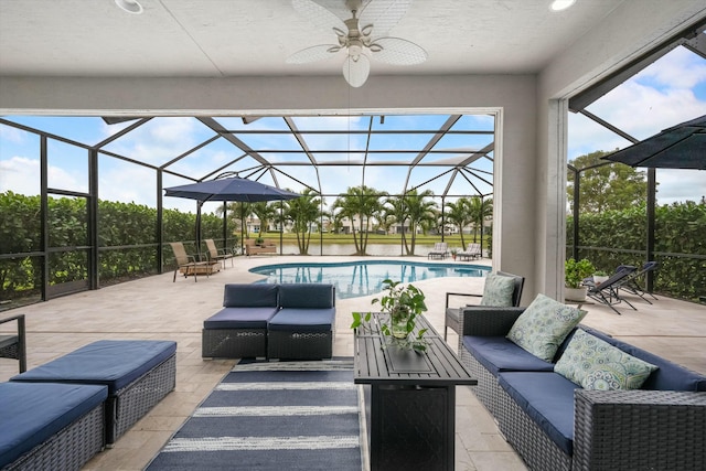 view of patio featuring ceiling fan, an outdoor living space, and a lanai