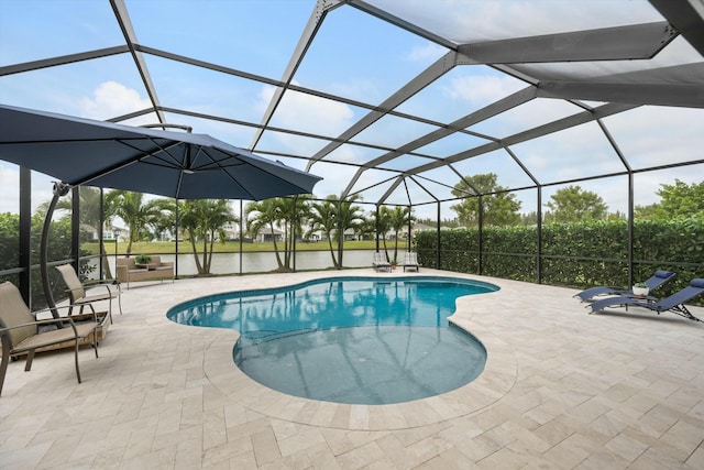 view of swimming pool featuring a water view, a patio area, and glass enclosure