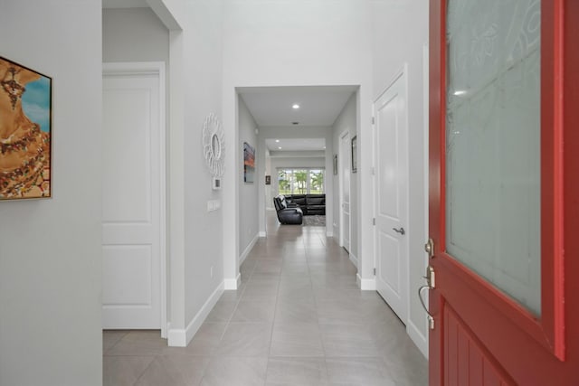 hall featuring light tile patterned floors