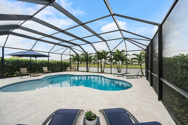 view of swimming pool featuring a lanai and a patio