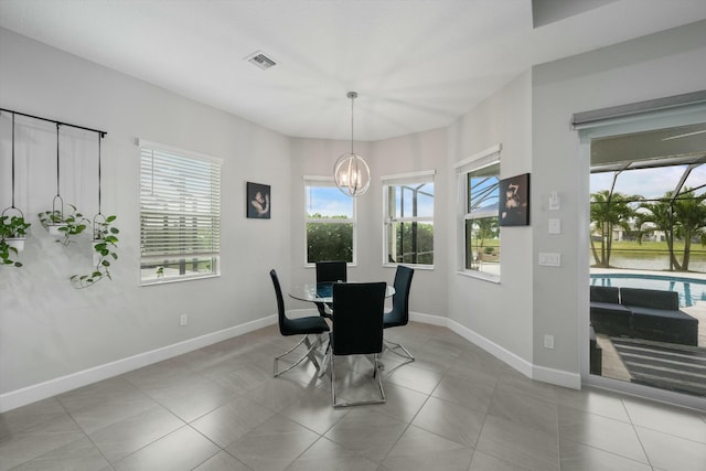 tiled dining area with a notable chandelier and a wealth of natural light