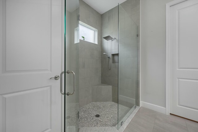 bathroom featuring an enclosed shower and tile patterned flooring