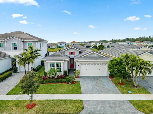 view of front of home with a front yard and a garage