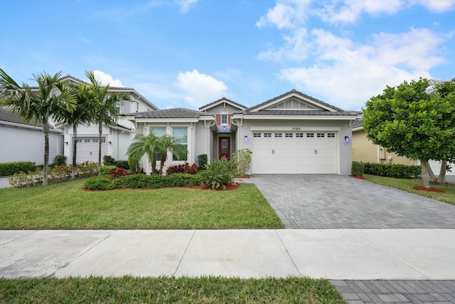 view of front of house featuring a front yard and a garage