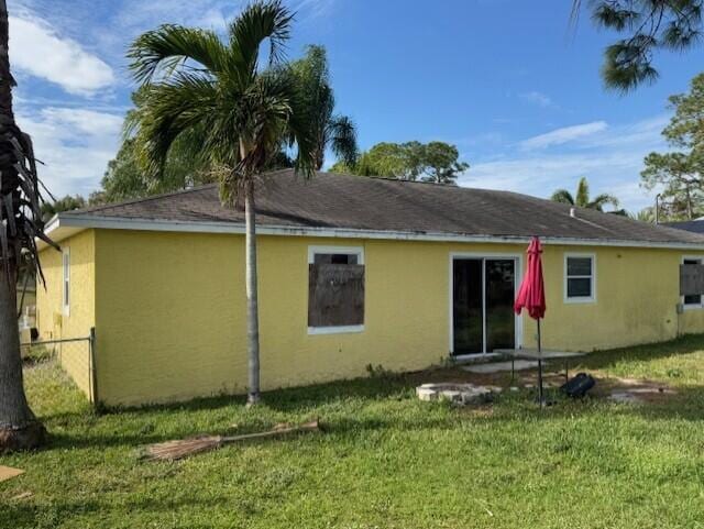 rear view of house with a lawn