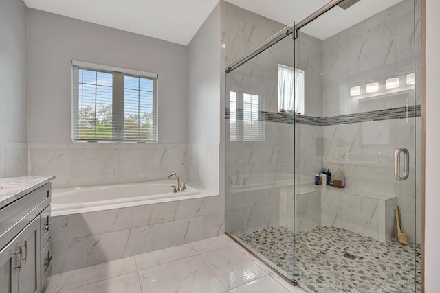 full bathroom featuring a marble finish shower, vanity, and a bath