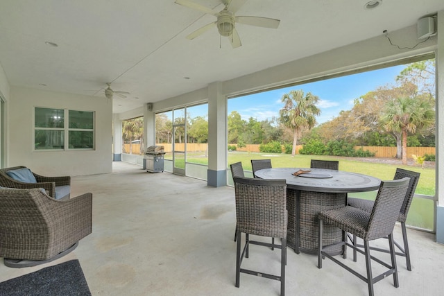 view of patio featuring a ceiling fan, outdoor dining area, a fenced backyard, and grilling area