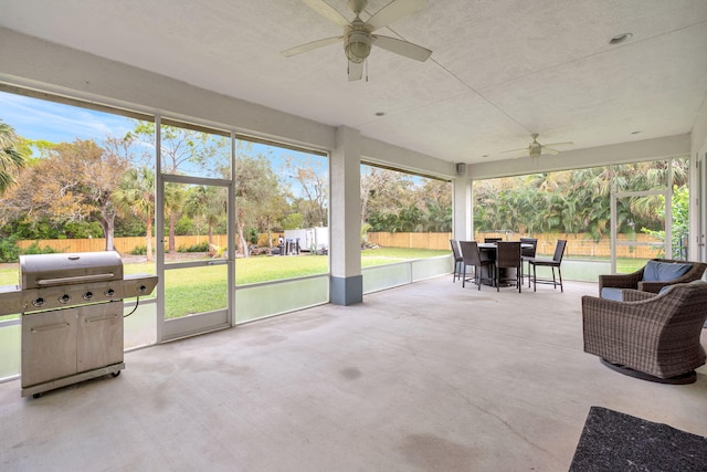 sunroom featuring ceiling fan