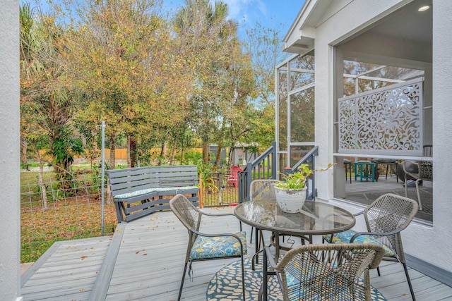 wooden terrace with outdoor dining space