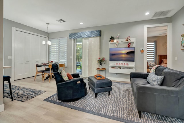 living room with visible vents, a chandelier, wood finished floors, and recessed lighting