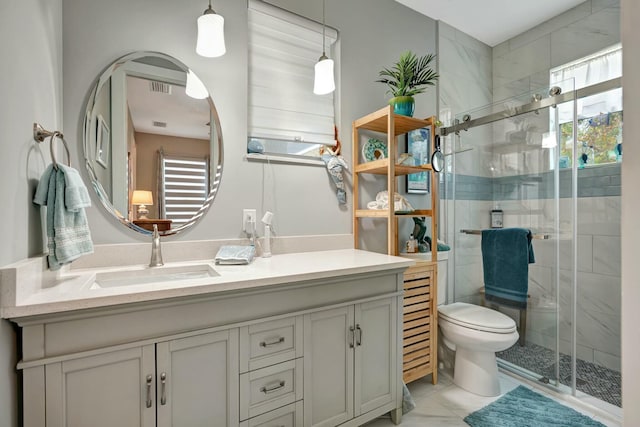 bathroom with toilet, visible vents, a stall shower, and vanity