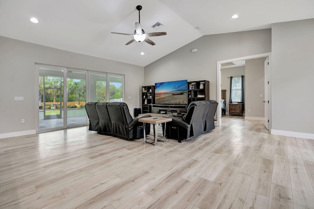 living room featuring lofted ceiling, ceiling fan, a healthy amount of sunlight, and light hardwood / wood-style floors