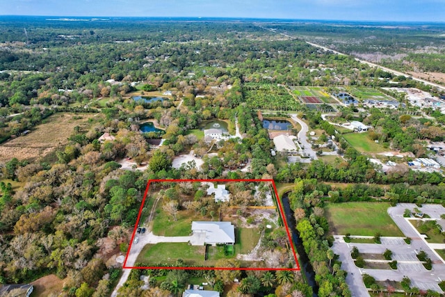 drone / aerial view with a wooded view