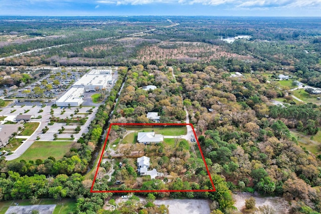 bird's eye view featuring a wooded view