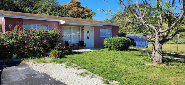 ranch-style house with a front lawn