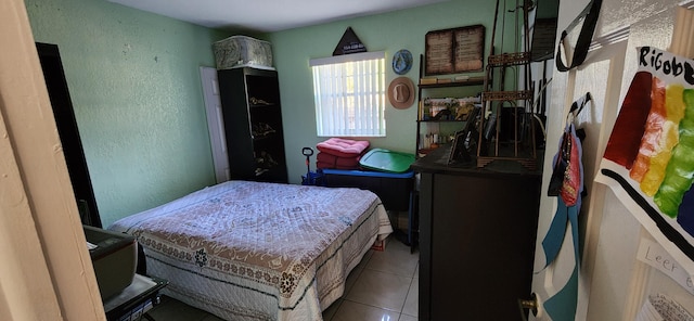 bedroom featuring light tile patterned flooring