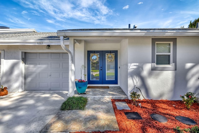 doorway to property featuring a garage and french doors