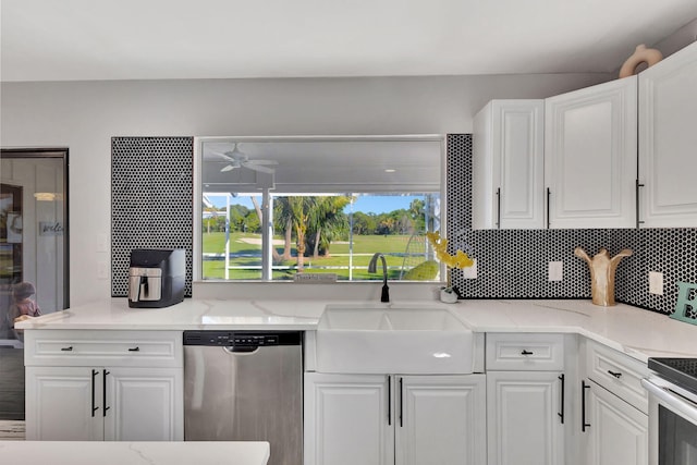 kitchen featuring sink, white cabinetry, ceiling fan, stainless steel appliances, and decorative backsplash