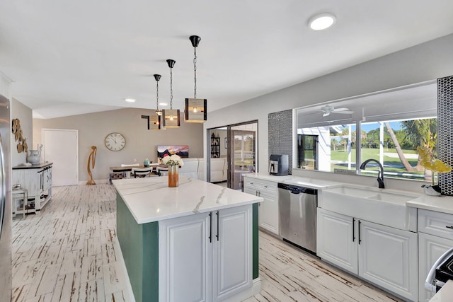 kitchen featuring pendant lighting, ceiling fan, dishwasher, white cabinetry, and a center island