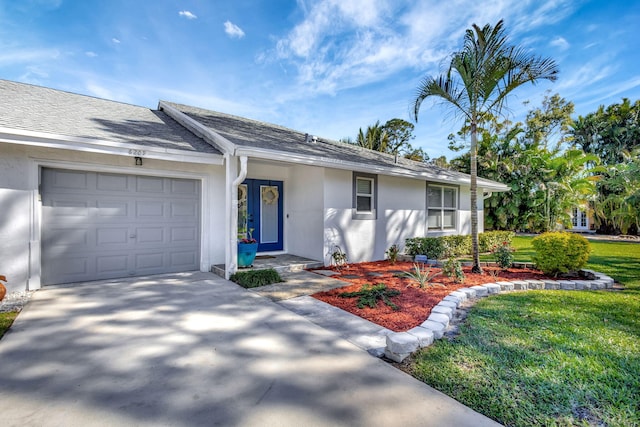 ranch-style house with a garage and a front yard