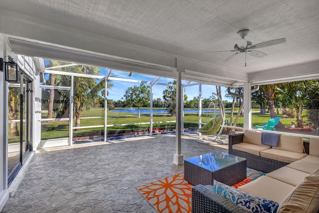 unfurnished sunroom featuring ceiling fan