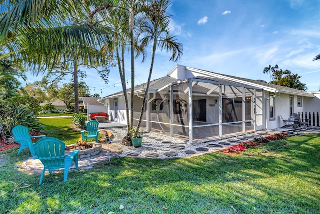 back of property featuring a patio, a lanai, and a yard