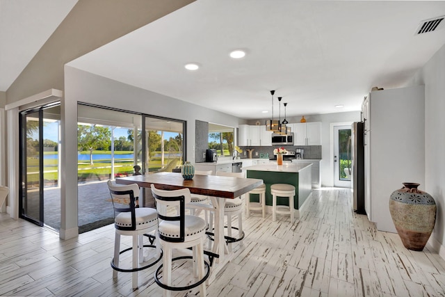 dining room featuring vaulted ceiling