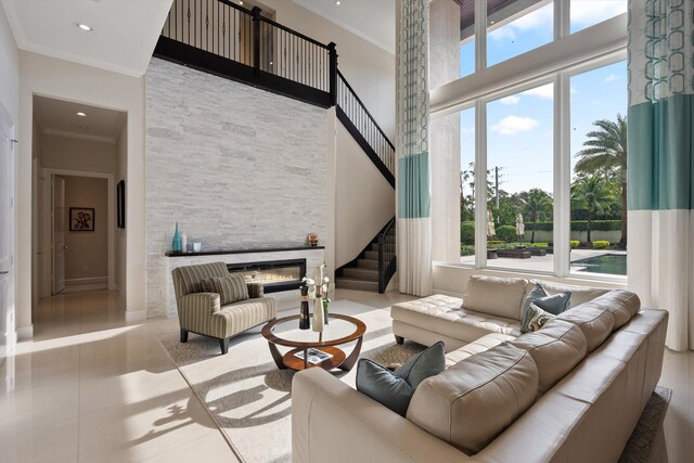 living room with a stone fireplace and light tile patterned flooring