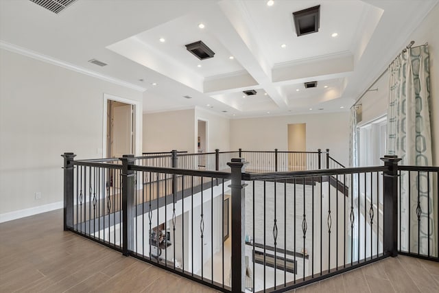 hallway featuring ornamental molding, beam ceiling, and coffered ceiling