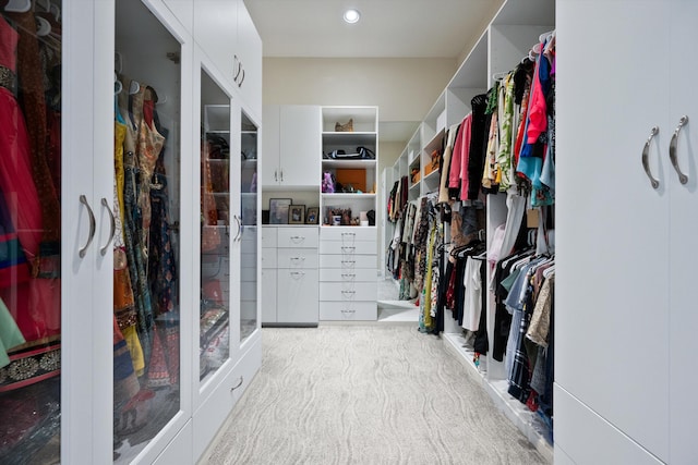 spacious closet featuring light carpet