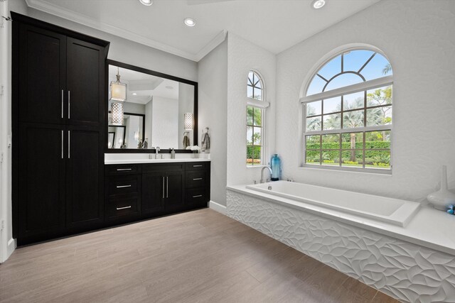 bathroom featuring walk in shower, vanity, and crown molding