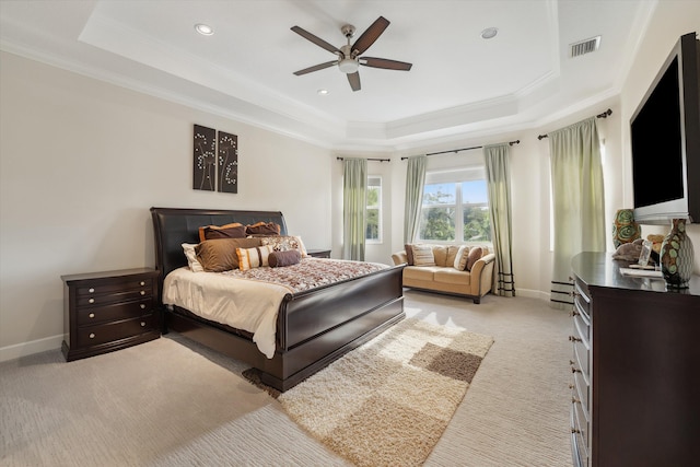 bedroom featuring light carpet, ceiling fan, a raised ceiling, baseboard heating, and ornamental molding