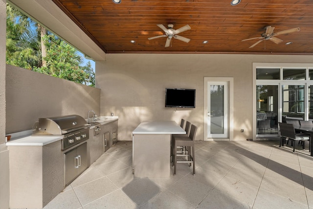 view of patio featuring ceiling fan, sink, a grill, and area for grilling