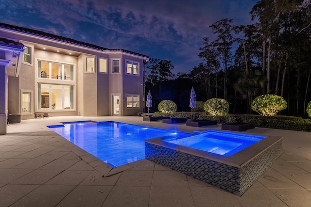 view of swimming pool with an in ground hot tub and a patio