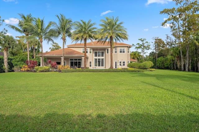 back of house with a lawn