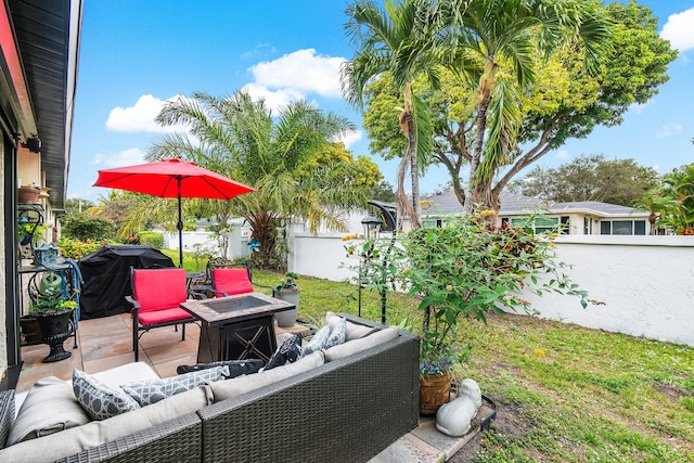 view of patio / terrace with an outdoor living space with a fire pit and area for grilling