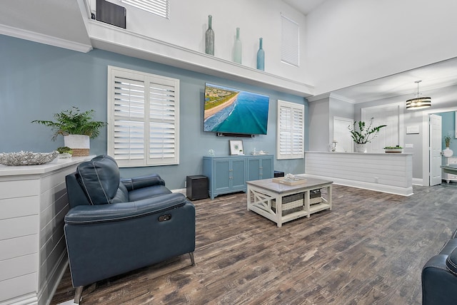 living room with dark wood-type flooring and crown molding