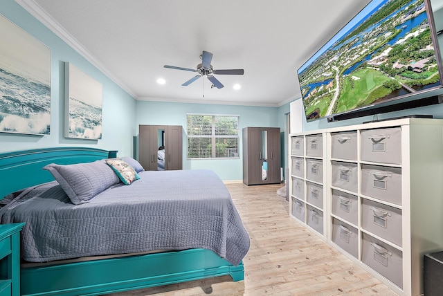 bedroom with ceiling fan, light wood-type flooring, and ornamental molding