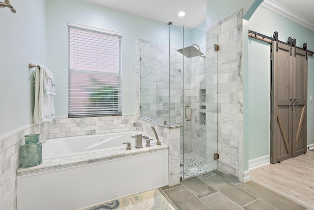 bathroom with ornamental molding, plus walk in shower, and wood-type flooring