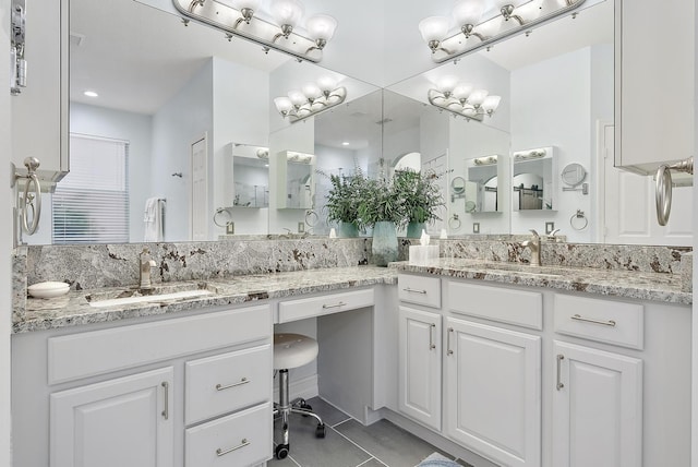 bathroom featuring tile patterned flooring and vanity