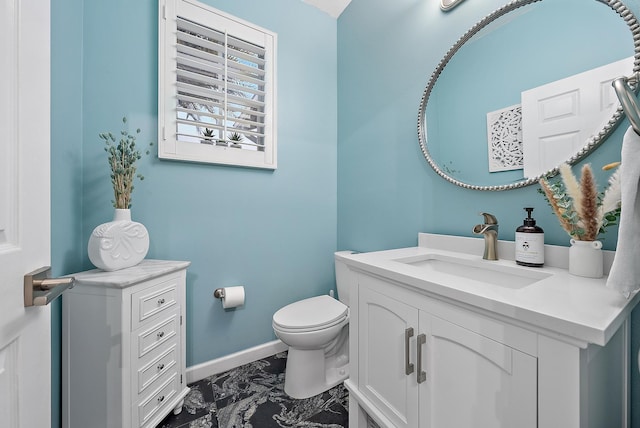 bathroom featuring toilet and vanity