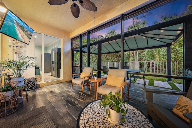 sunroom featuring ceiling fan